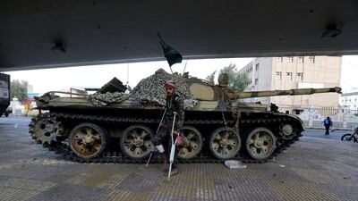 A wounded Houthi fighter walks past a tank at a street leading to the house of Yemeni ex-president Ali Abdullah Saleh. Saleh was killed in Sanaa, Yemen on December 4. Yahya Arhab / EPA