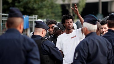 Migrants stand in line as French police evacuate hundreds of migrants living in makeshift camps in Paris, France. Benoit Tessier / Reuters