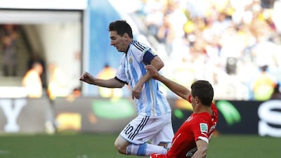 Lionel Messi dribbles by Fabian Schar during Argentina's win over Switzerland on Tuesday at the 2014 World Cup. Paul Hanna / Reuters / July 1, 2014