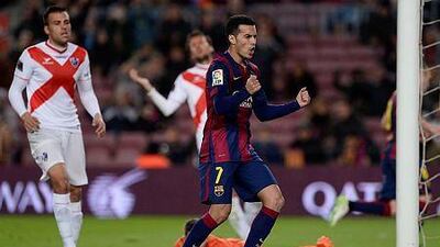 Barcelona's forward Pedro Rodriguez celebrates a goal by his teammate Barcelona's midfielder Andres Iniesta during the Spanish Copa del Rey (King's Cup) round of 32 second leg football match against S.A.D. Huesca at the Camp Nou stadium in Barcelona on December 16, 2014. AFP PHOTO/ JOSEP LAGO