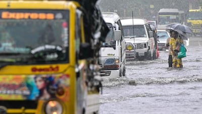 People wade through a flooded road in Biyagama, on the outskirts of Colombo. AFP