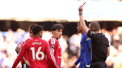 Manchester United's Lisandro Martinez is shown a red card by referee Peter Bankes after a VAR review. Reuters