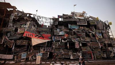 Iraqis walk past the site of an explosion which killed more than 300 people in Baghdad’s Karrada district on July 3. Ahmad Al Rubaye / AFP Photox