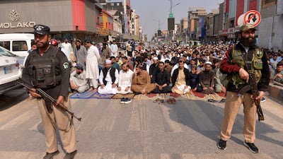 Pakistani security troops guard worshippers performing Friday prayers in Peshawar, near the border with Afghanistan. EPA