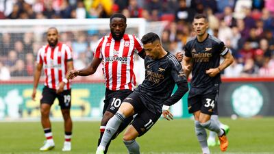 Arsenal's Gabriel Martinelli in action with Brentford's Josh Dasilva. Reuters