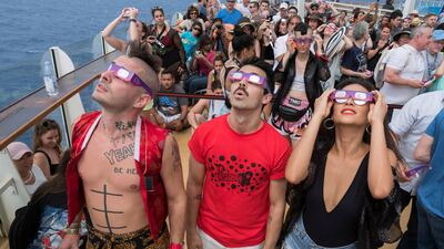 Cole Whittle, left, and Joe Jonas of multi-platinum-selling band DNCE, joined actress Shay Mitchell to celebrate the Great American Eclipse aboard Royal Caribbean's Oasis of the Seas. The ship set sail along the path of totality, offering guests a once-in-a-lifetime view of the epic celestial event. Charles Sykes / Invision for Royal Caribbean International / AP Images