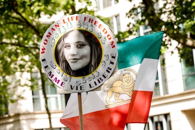 A demonstrator carries the portrait of Mahsa Amini, who died in detention following her arrest by the Iranian morality police in September 2022, during a demonstration near the Iranian embassy in Paris, France, 23 May 2023. EPA