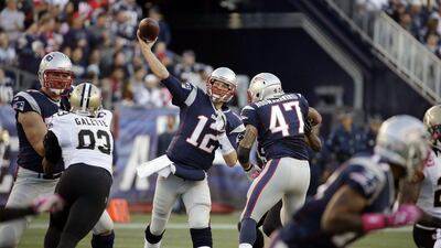 Tom Brady, center, threw his only touchdown pass on Sunday with five seconds left to win it for New England. Stephan Savoia / AP