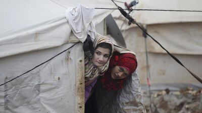 Girls look at the storm from their tent inside Al Karameh refugee camp on the Syrian-Turkish border in Idlib. Khalil Ashawi / Reuters