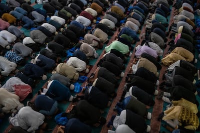 Men take part in morning prayers during Eid Al-Fitr celebrations at East London Mosque. Getty Images