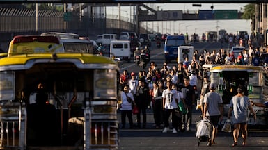 Passengers are seen waiting for available public transportation amid a strike by jeepney drivers in Manila. Reuters