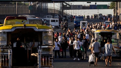 Passengers are seen waiting for available public transportation amid a strike by jeepney drivers in Manila. Reuters