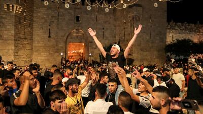 Palestinians celebrate outside Damascus Gate after barriers that were put up by Israeli police are removed, allowing them to access the main square on April 25, 2021. Reuters