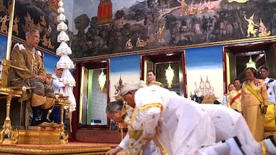 This screengrab shows Chief Brahmin Phra Ratcha Khru Vamadeb Muni (front) addressing Thailand's King Maha Vajiralongkorn (left) during his coronation in Bangkok. AFP
