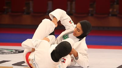 Asma Al Hosani of the UAE (red) beat Emirati Shamsa Al Ameri in the 52kg final. Pawan Singh / The National