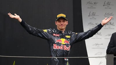 Max Verstappen celebrates on the podium after finishing third at the Brazilian Grand Prix. Clive Mason / Getty Images