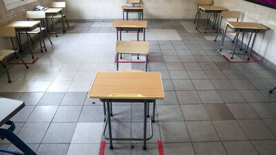 Markers on the floors indicate social distancing rules for the pupils
