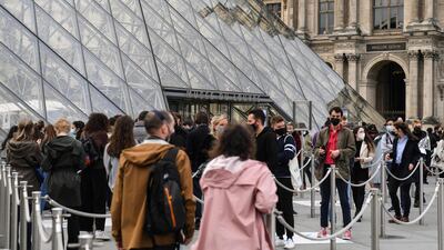 People queue outside the Louvre Museum in Paris, as museums reopen in France today as part of an easing of the nationwide lockdown. AFP