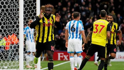 Isaac Success celebrates scoring Watford's third goal in a 3-0 win at home to Huddersfield Town. Reuters