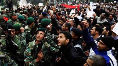 Soldiers hold back a crowd of protesters in Tunis in January. Khalid al Safi al Haribi, the managing director of Tawasul, says similar scenes can be expected in Oman before the end of the year.
