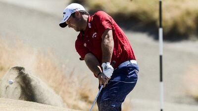 Patrick Reed hits his second shot from a sand trap by the second green. Paul Buck / EPA / June 20, 2015