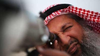 Hasan Hariri, a member of the official moon spotting team, uses his telescope to look for the moon to signal the start of Ramadan yesterday.