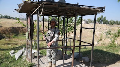 An Afghan security official stands guard on a roadside check point as the Taliban declared a three-day ceasefire during Eid Al Fitr, which marks the end of Ramadan. EPA