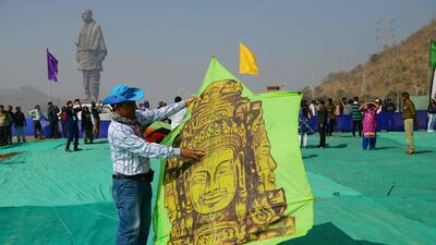 A Cambodian participant prepares to fly a kite decorated with an image of an Angkor Wat monument. AFP