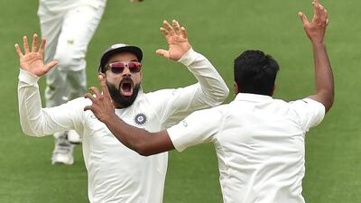 India captain Virat Kohli, left, celebrates with spin bowler Ravichandran Ashwin after beating Australia to win the first Test at Adelaide Oval. AFP