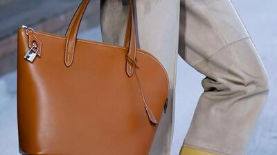 At Hermes, it is always the details that count, and here what might be the season's best flats are teamed with striped hem trousers, and, of course, a bag. AFP, Bertrand GUAY