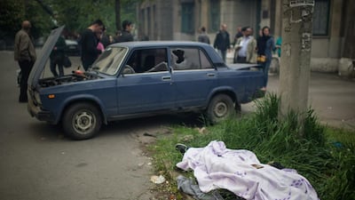 A covered dead body near the Mariupol police station, Ukraine. Two eastern Ukrainian provinces will go ahead with a referendum on seceding from the country as planned this weekend despite Russian President Vladimir Putin’s call for a delay, separatist leaders told Russia’s Interfax news agency. Alexy Furman / EPA
