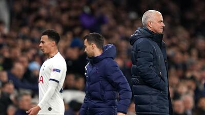 Dele Alli reacts badly to coming off as he passes manager Jose Mourinho. PA