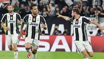 Dani Alves, centre, celebrates after scoring the second Juventus goal in the 2-1 win over Monaco in the Uefa Champions League semi-final second leg on Tuesday. Andrea Di Marco / EPA