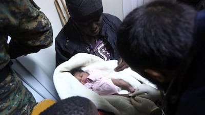 A Libyan aid worker inspects an illegal immigrant child who was rescued with others at sea off the coast of Libya, at a reception centre in the capital Tripoli, on February 5, 2017. More than 120 migrants were rescued by Libyan coastguards off the coast of Tripoli, a day after authorities said they had intercepted more than 400 people attempting the sea crossing to Europe. AFP / MAHMUD TURKIA