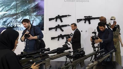 Visitors try out the various firearms at the Kalashnikov stand. Satish Kumar / The National