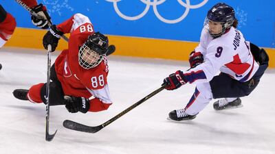 Phoebe Staenz (L) of Switzerland in action against Jongah Park (R) of Korea during the women's Ice Hockey Classifications match between Switzerland and Korea at the Kwandong Hockey Centre. Srdjan Suki / EPA