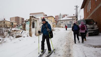Skiing enthusiasts ski down the snow covered streets of the Kosovo capital Pristina. Visar Kryeziu / AP Photo