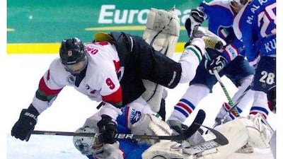 UAE's Omar Al Shamsi, left, collides with Kuwait's goalkeeper Jasim Alsraf last night in the final of the Gulf Cup. Christopher Pike / The National