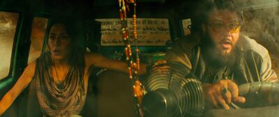 This image released by Warner Bros. Pictures shows Sarah Shahi, left, and Mohammed Amer in a scene from "Black Adam. " (Warner Bros. Pictures via AP)