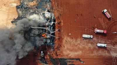 Flames send plumes of black smoke billowing into the sky at the site.