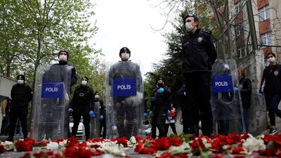 Carnations are seen spread on the ground in front of Turkish police officers as trade union leaders attempt to defy a ban and march on Taksim Square to celebrate May Day, during a three-day curfew in Istanbul, Turkey. Reuters