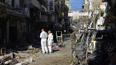 Lebanese police inspect the damage at the site of a twin suicide attack in the Bourj Al Barajneh suburb of Beirut. Wael Hamzeh / EPA