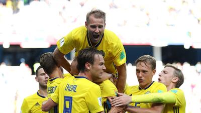Andreas Granqvist, left, celebrates after Sweden's decisive penalty against South Korea. Clive Brunskill / Getty Images