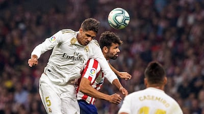 Real Madrid's French defender Raphael Varane beats Atletico Madrid's Diego Costa to the ball. EPA