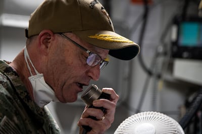 Vice Admiral William Merz, commander US 7th Fleet, speaks to navy sailors assigned to the aircraft carrier during a coronavirus outbreak on the ship at Naval Base Guam. US Navy via Reuters