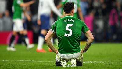 Brighton's Lewis Dunk looks dejected after Christian Eriksen's goal. Reuters