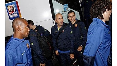 Barcelona's French defender Eric Abidal, left, and teammate Gabriel Milito, right, arrive at their hotel in Abu Dhabi.