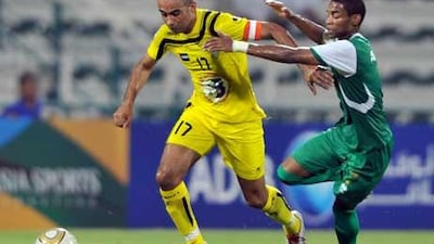 Al Wasl’s Alexander Olivera, left, runs away from Al Shabab’s Mohamed Ali Alawi.