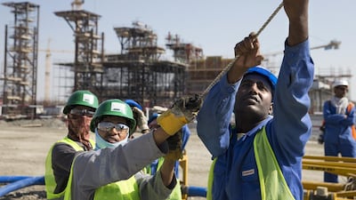 Labourers help to keep in place a piece of the steel dome of Louvre Abu Dhabi. Silvia Razgova / The National
