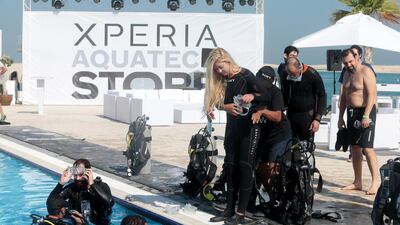 Journalists receive instructions before being diving at Sony’s Xperia Aquatech Store. Christopher Pike / The National